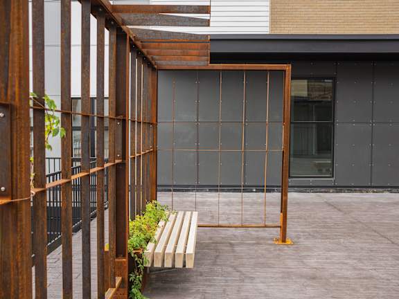 A wooden structure with glass panels is in the foreground.