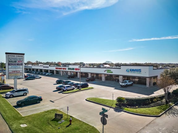 a shopping center with cars parked in front of it