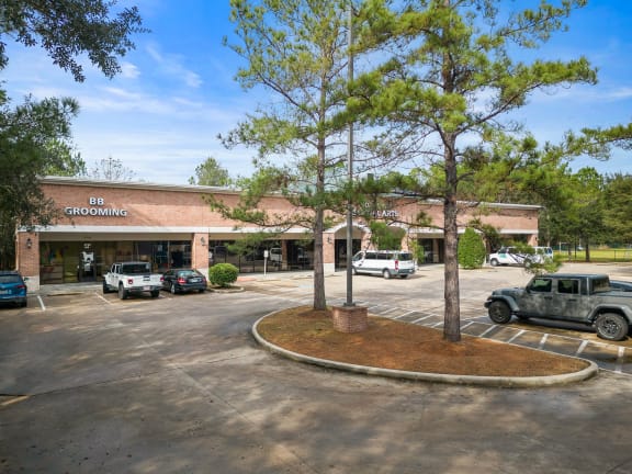 a large brick building with a parking lot in front of it
