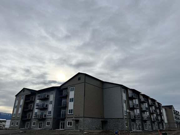a building with a cloudy sky in the background