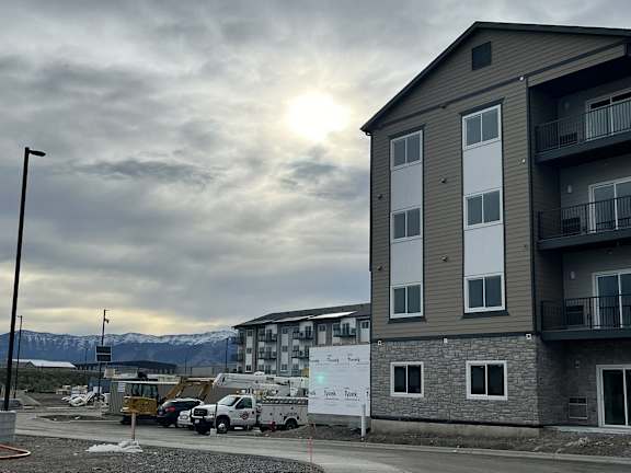 a new apartment building is being constructed on the corner of a street