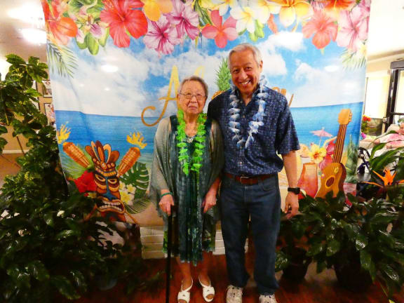 a man and a woman standing in front of a mural
