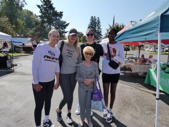a group of people posing for a picture at a farmers market