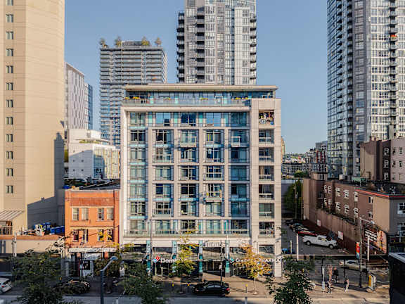 an aerial view of a building in a city with tall buildings