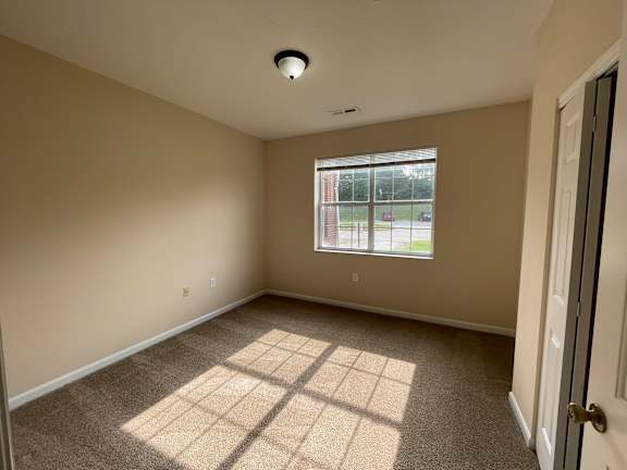 A room with a window and a door.
