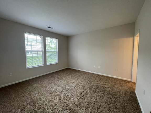 A room with carpeted floor and a window.at Twin Fountains, Ohio