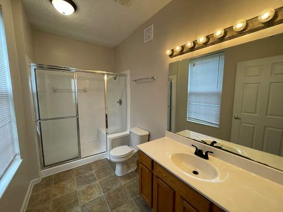 A bathroom with a toilet, sink, and shower.at Twin Fountains, Ohio