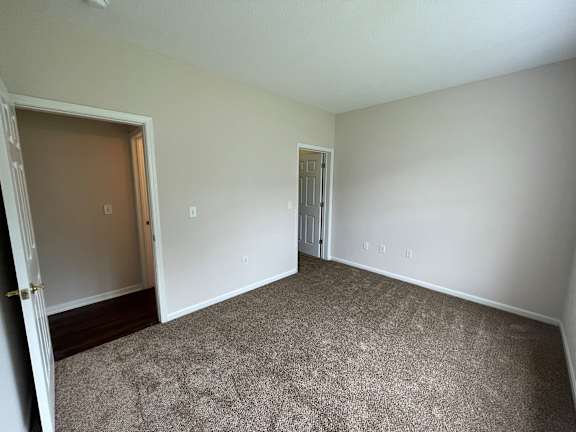 A room with carpeted floor and two doors.at Twin Fountains, Mason, OH 45040