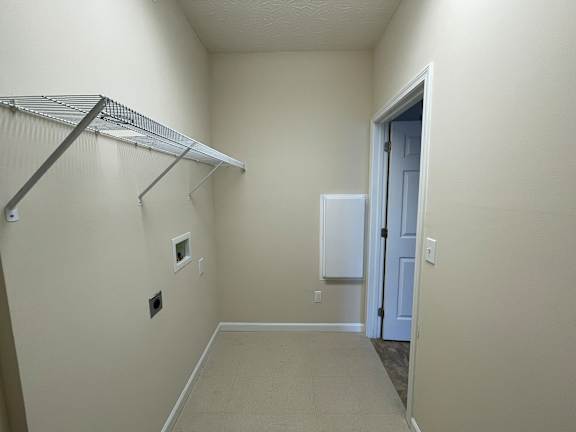 A white closet with a white door and a white shelf. at The Legends at Steeplechase, Richwood, Kentucky