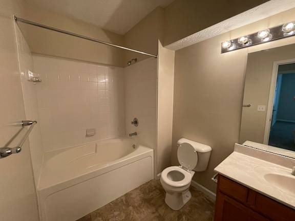 A white bathroom with a toilet, sink, and bathtub. at The Legends at Steeplechase, Richwood, Kentucky