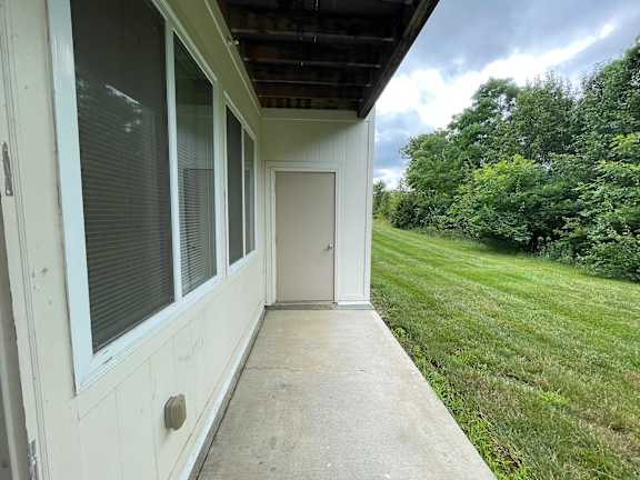 A white house with a door and windows is shown. at The Legends at Steeplechase, Richwood, 41094