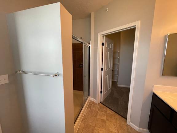 A white door is open to a bathroom.