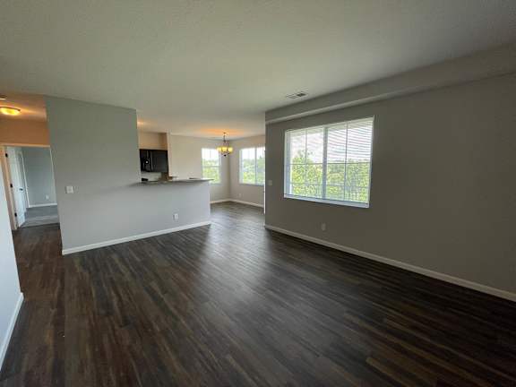 A room with wooden floors and a television.