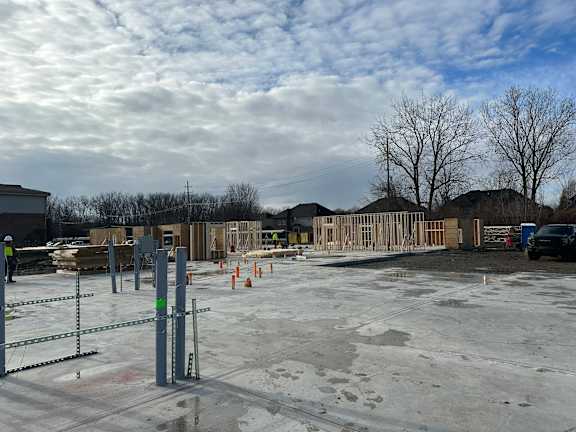 A construction site with a partly cloudy sky.