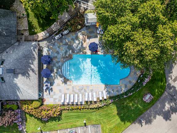 a birds eye view of the pool at a resort with umbrellas