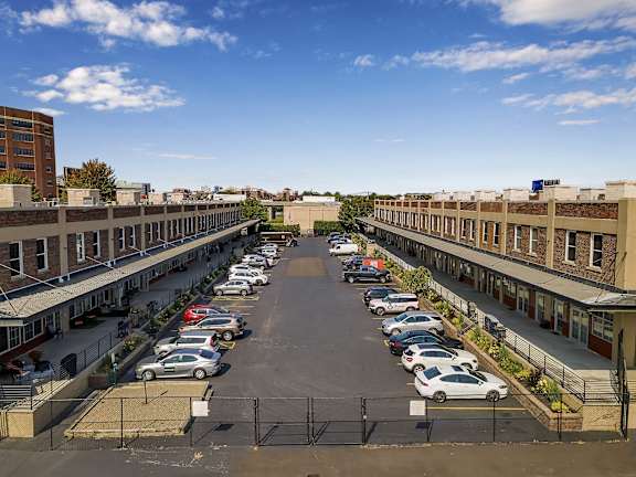 an aerial view of a parking lot with cars parked at The Lofts at Elk Terminal Apartments , New York