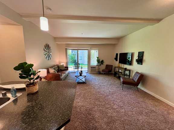 a living room with couches and chairs and a counter top at Mullan Reserve Apartments, Missoula, Montana
