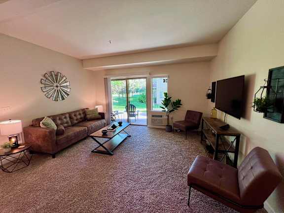 a living room with a couch and a tv at Mullan Reserve Apartments, Missoula, Montana