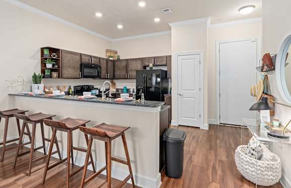 a living room with a couch and a television at Lake Lofts at Deerwood, Jacksonville, FL, 32216