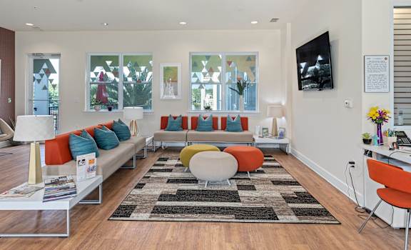 a living room with couches and chairs and a television