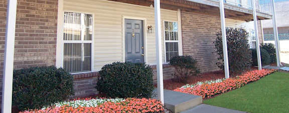 A house with a blue door and a white railing.