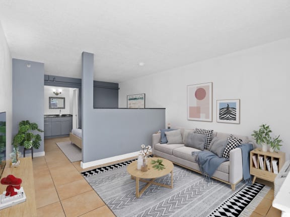 a living room with a couch and a table at Colonial Drive Apartments, Orlando, FL