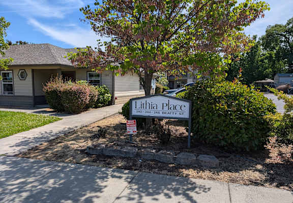 A sign in front of a house that says Lillian Place.