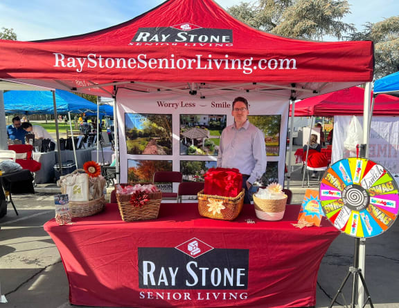 a man standing in front of a ray stone senior living tent