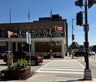 A desert spot restaurant is located on a busy street corner.