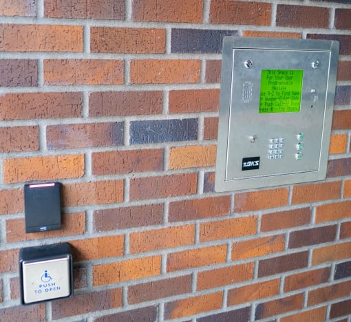 a brick wall with a light switch and buttons on it