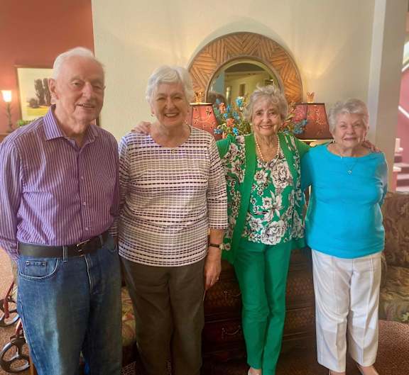 a group of people standing in a living room