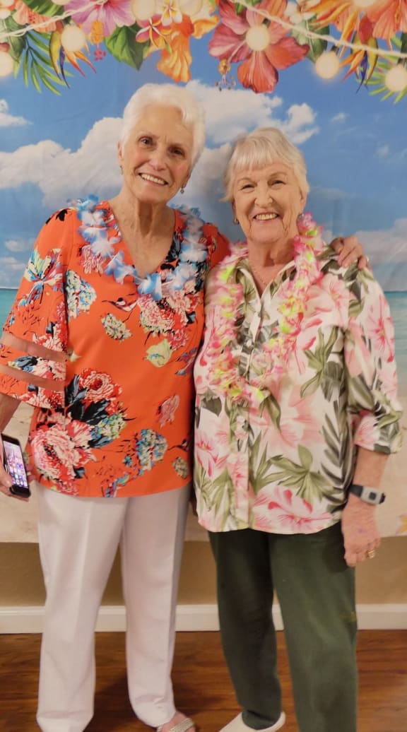two elderly women sitting at a table with a bottle of wine at Lodi Commons Senior Living, California, 95240