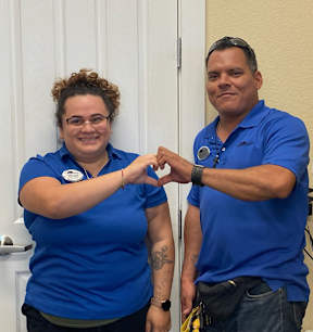 a man and a woman holding their hands in front of a door