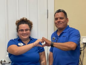 a man and a woman holding their hands in front of a door
