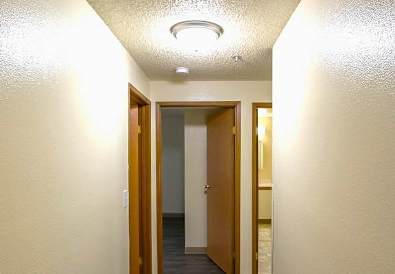 A long hallway with doors on both sides.
