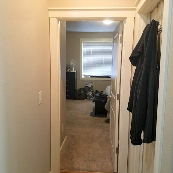 a look down the hallway from the living room to the bedroom