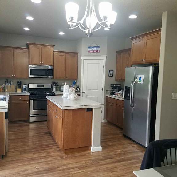 a kitchen with a center island and stainless steel appliances