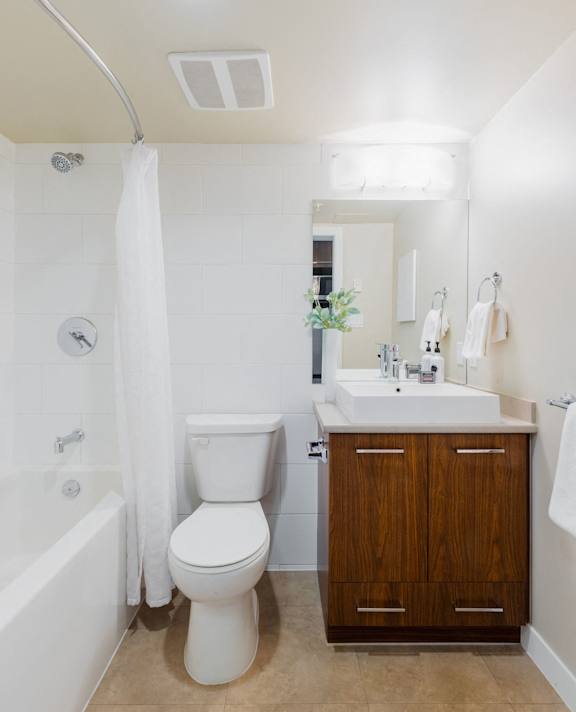 a bathroom with a toilet and a sink and a bath tub