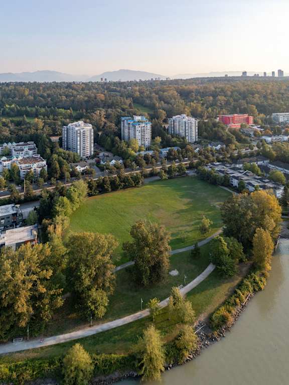 an aerial view of a park next to a river