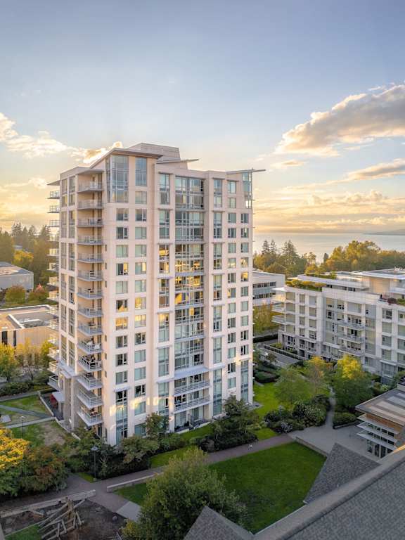 an aerial view of an apartment building in the sunset