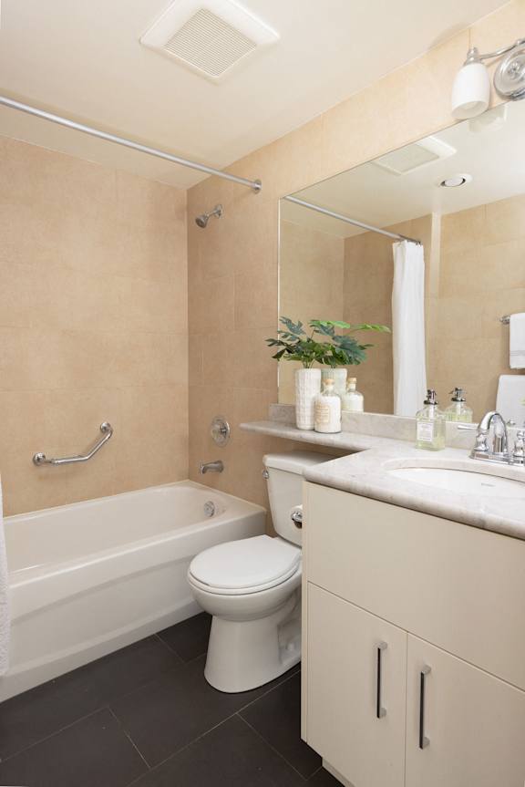 a bathroom with a toilet and a tub and a sink