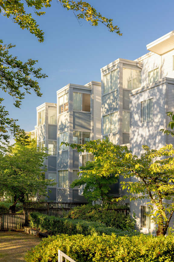 a tall building with trees in front of it