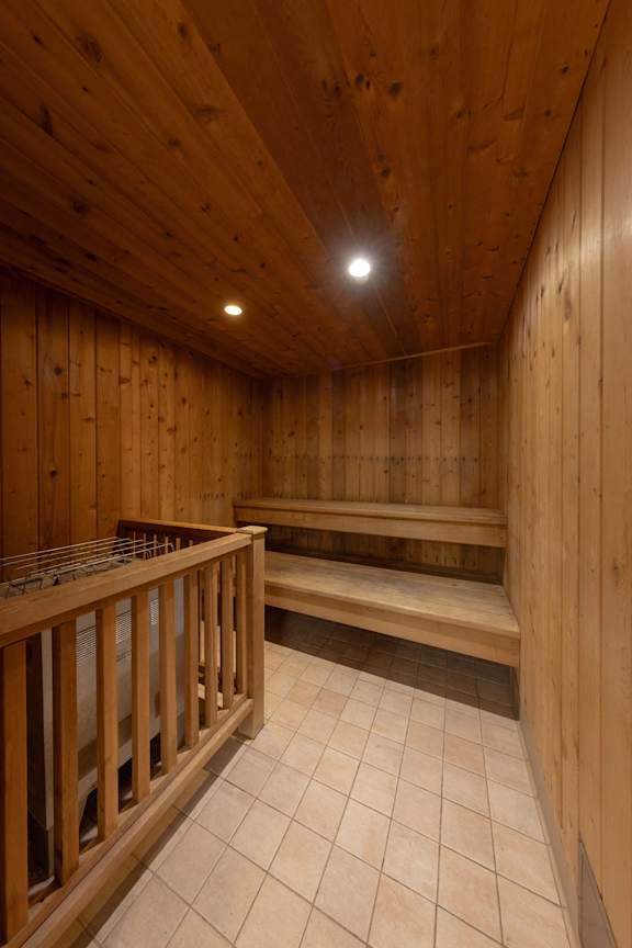 a sauna with wooden walls and wooden benches