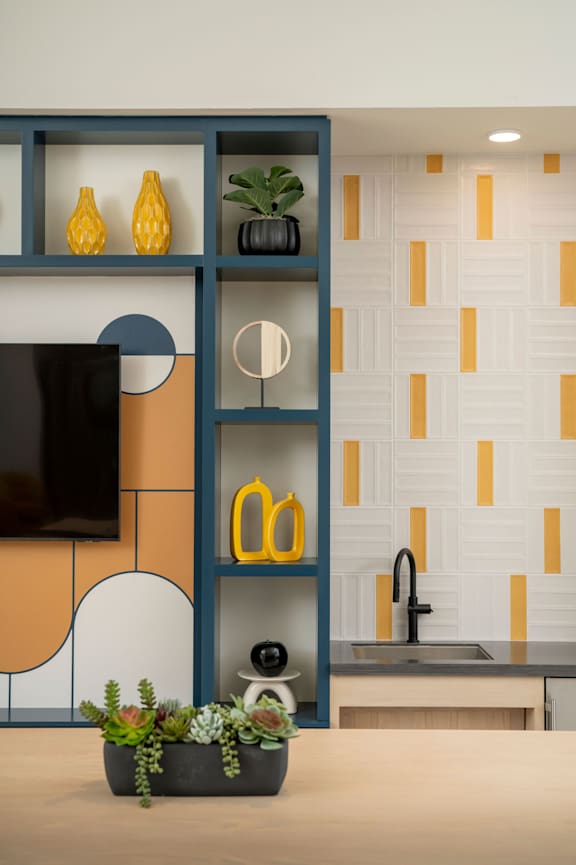 A modern kitchen with a blue shelf and a sink.