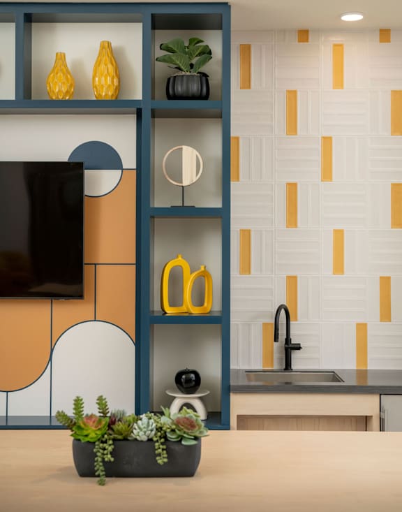 A kitchen with a wooden shelf and a sink.