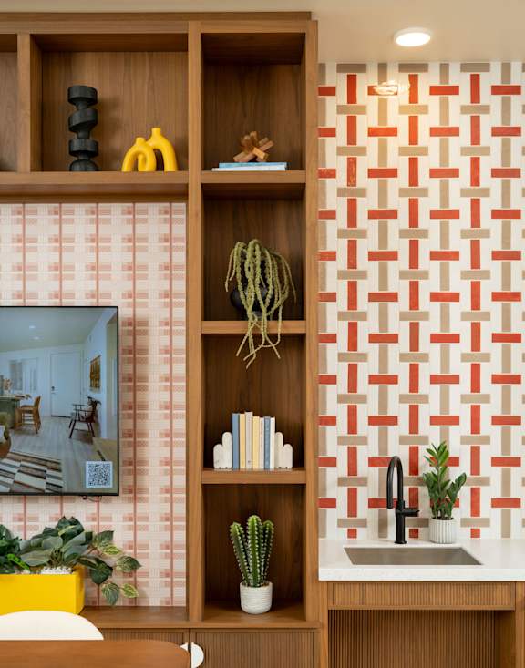 A kitchen with a wooden shelf and a sink.