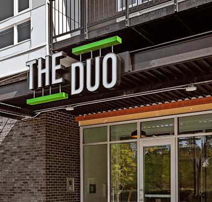 a building with a sign that reads the duo on the front of it at The Duo, Washington, 98466