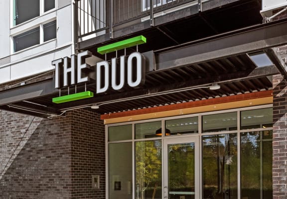 a building with a sign that reads the duo on the front of it at The Duo, Washington, 98466