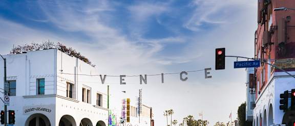 A white building with the word "Venice" written on a banner across the front.