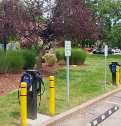 a row of electric bicycles parked in a parking lot